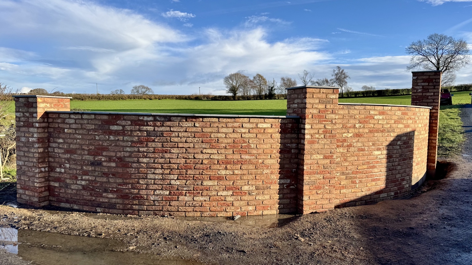 Completed pair of curved brick entrance walls
