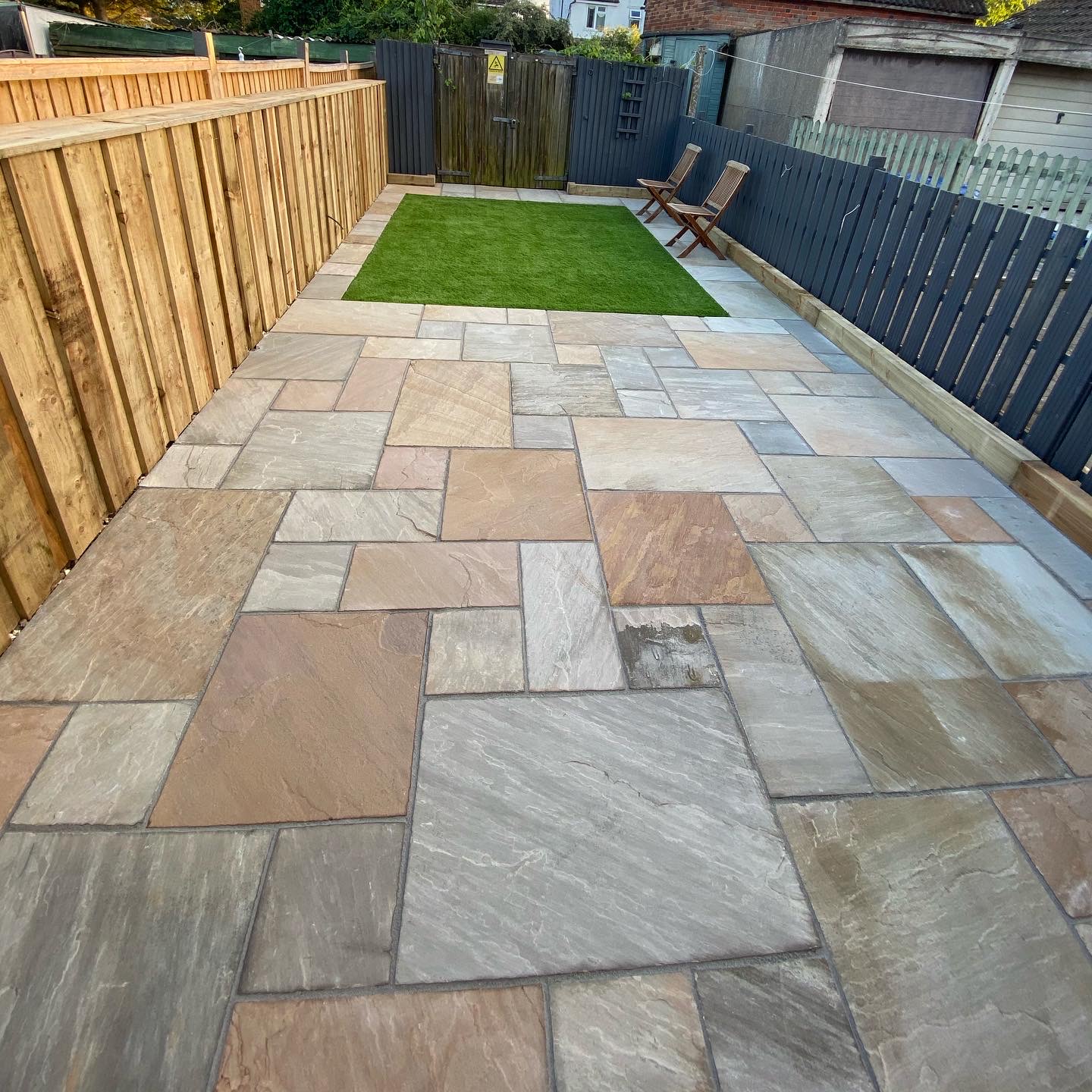 Finished Indian sandstone patio with artificial grass