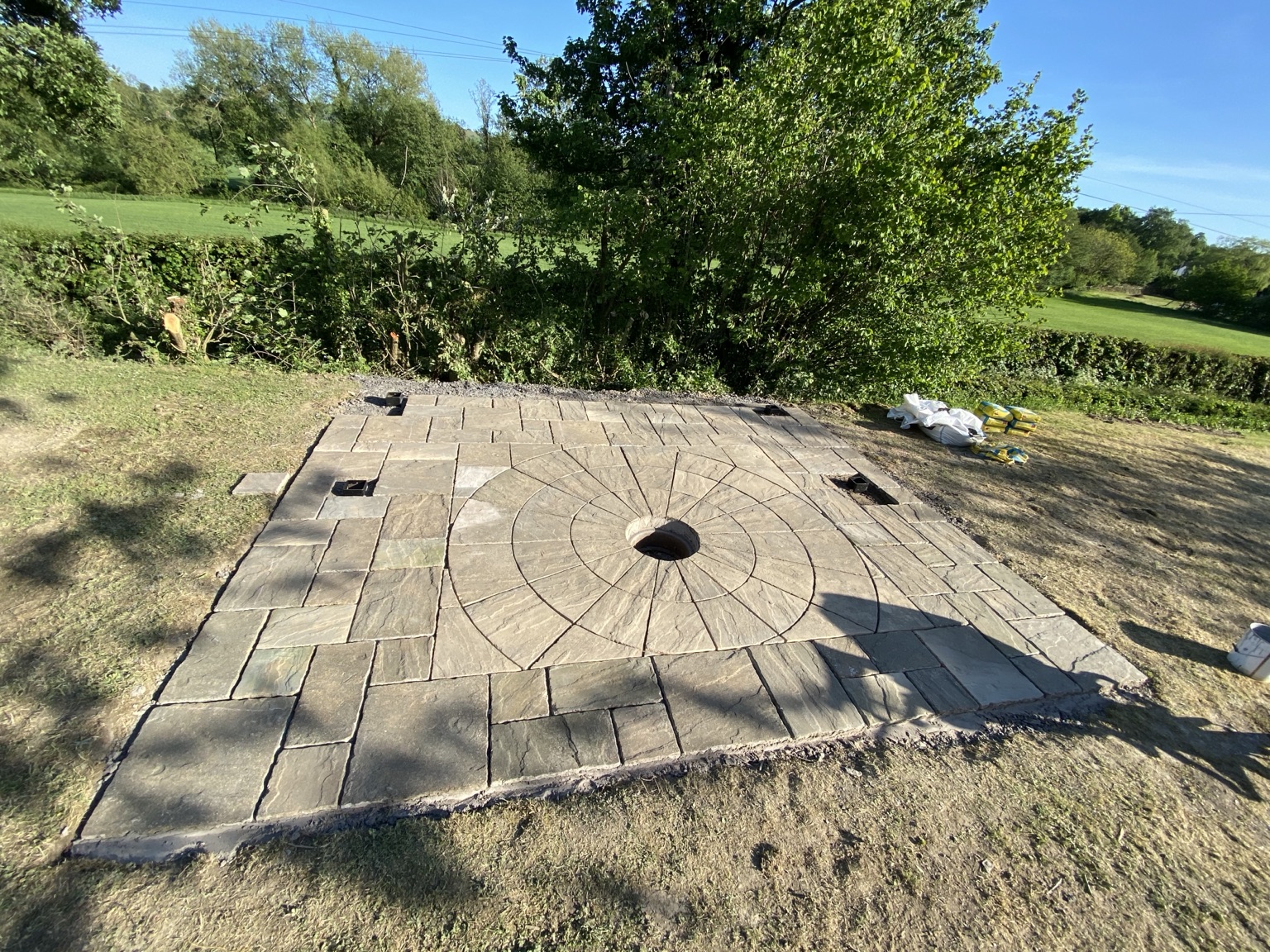 Indian sandstone patio with a circular feature