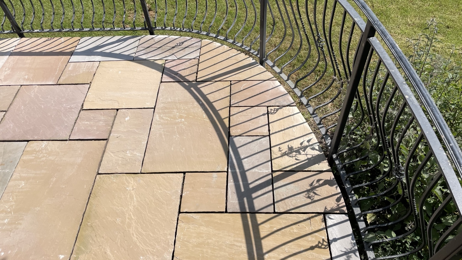 Close detail of Indian sandstone slabs around curved railings