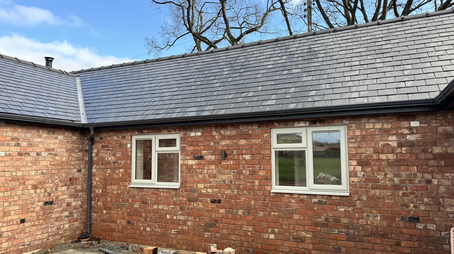 Finished brick elevations and slate roof around the courtyard