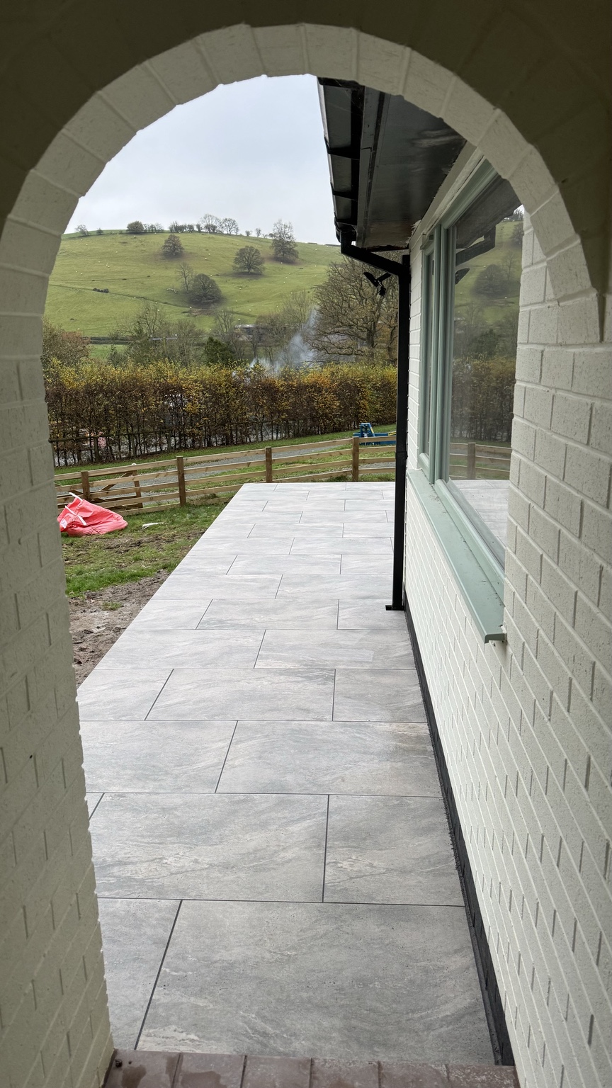 Porcelain patio viewed through the house archway